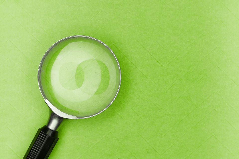 A magnifying glass on a green background